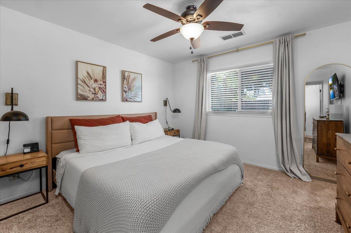 1448 Ashcroft Avenue Clovis, CA 93611 - Photo 23 of 46 a bedroom with a bed and a chandelier