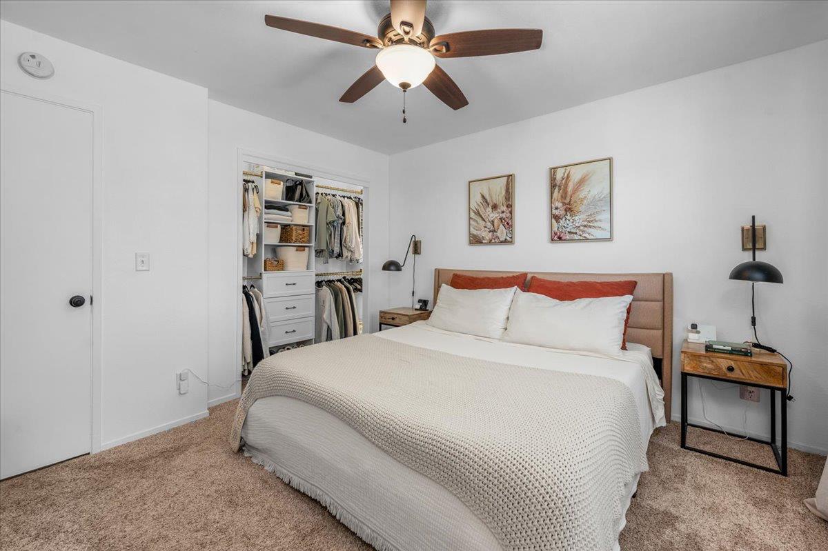 1448 Ashcroft Avenue Clovis, CA 93611 - Photo 24 of 46 a bedroom with a bed and a chandelier