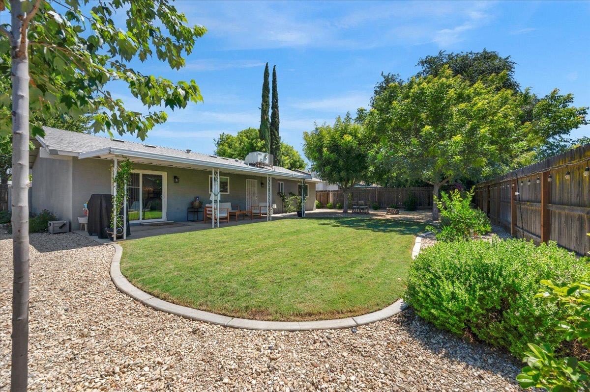 1448 Ashcroft Avenue Clovis, CA 93611 - Photo 33 of 46 a view of a house with backyard sitting area and garden