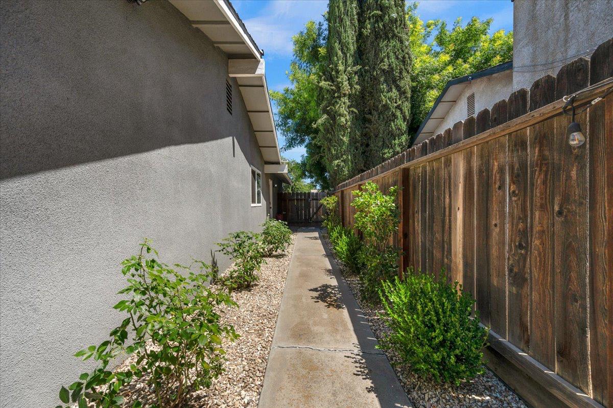 1448 Ashcroft Avenue Clovis, CA 93611 - Photo 35 of 46 a backyard with potted plants and wooden fence