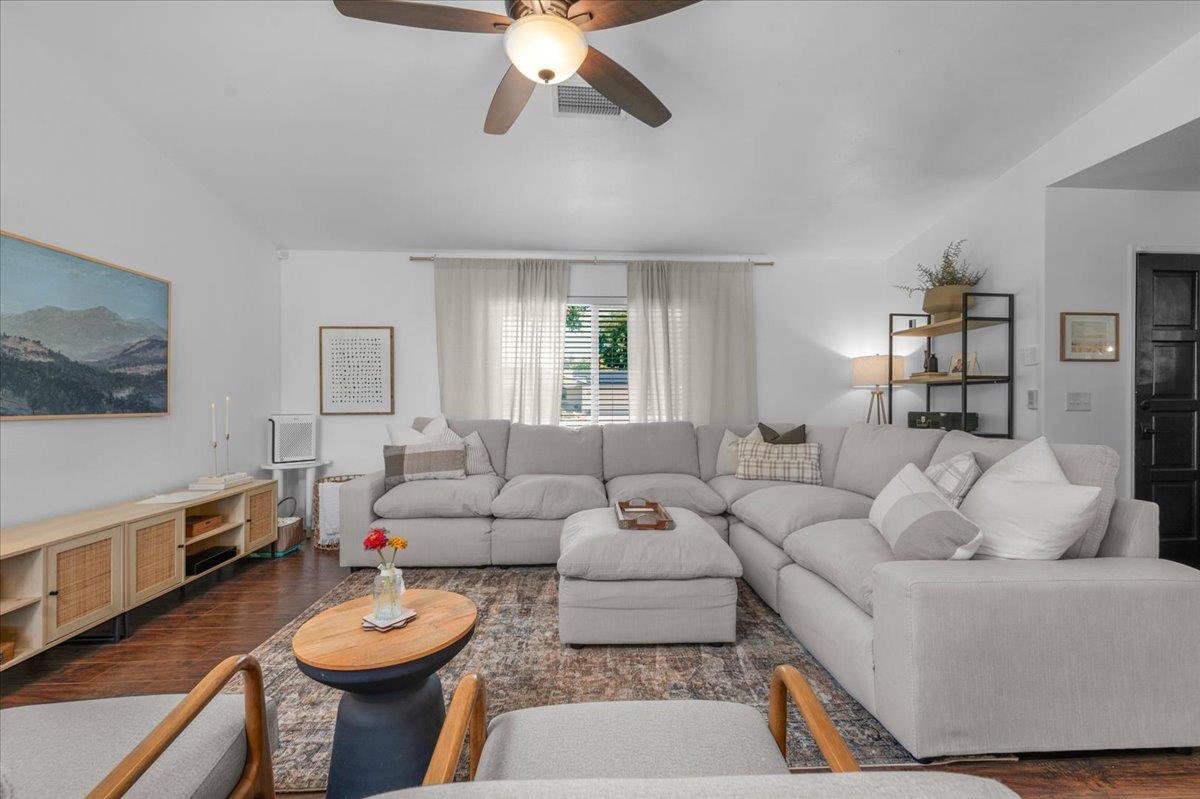 1448 Ashcroft Avenue Clovis, CA 93611 - Photo 6 of 46 a living room with furniture a rug and a flat screen tv