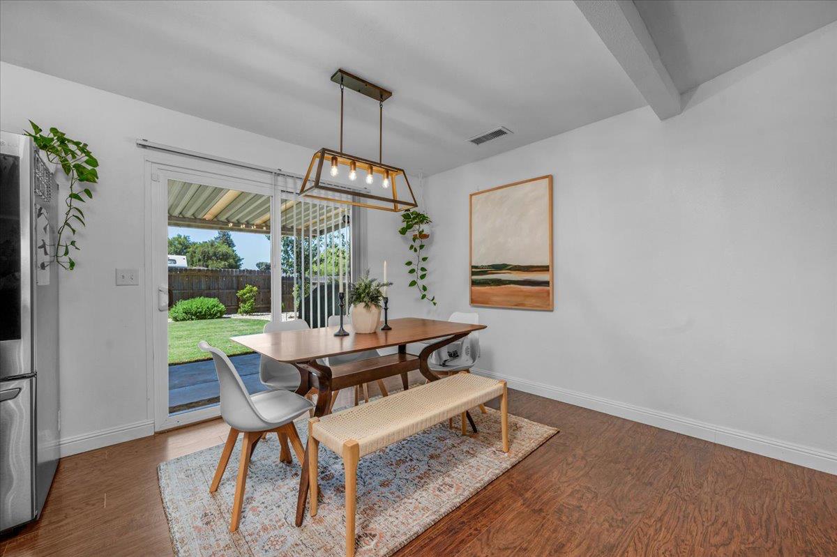 1448 Ashcroft Avenue Clovis, CA 93611 - Photo 9 of 46 a view of a dining room with furniture wooden floor and chandelier