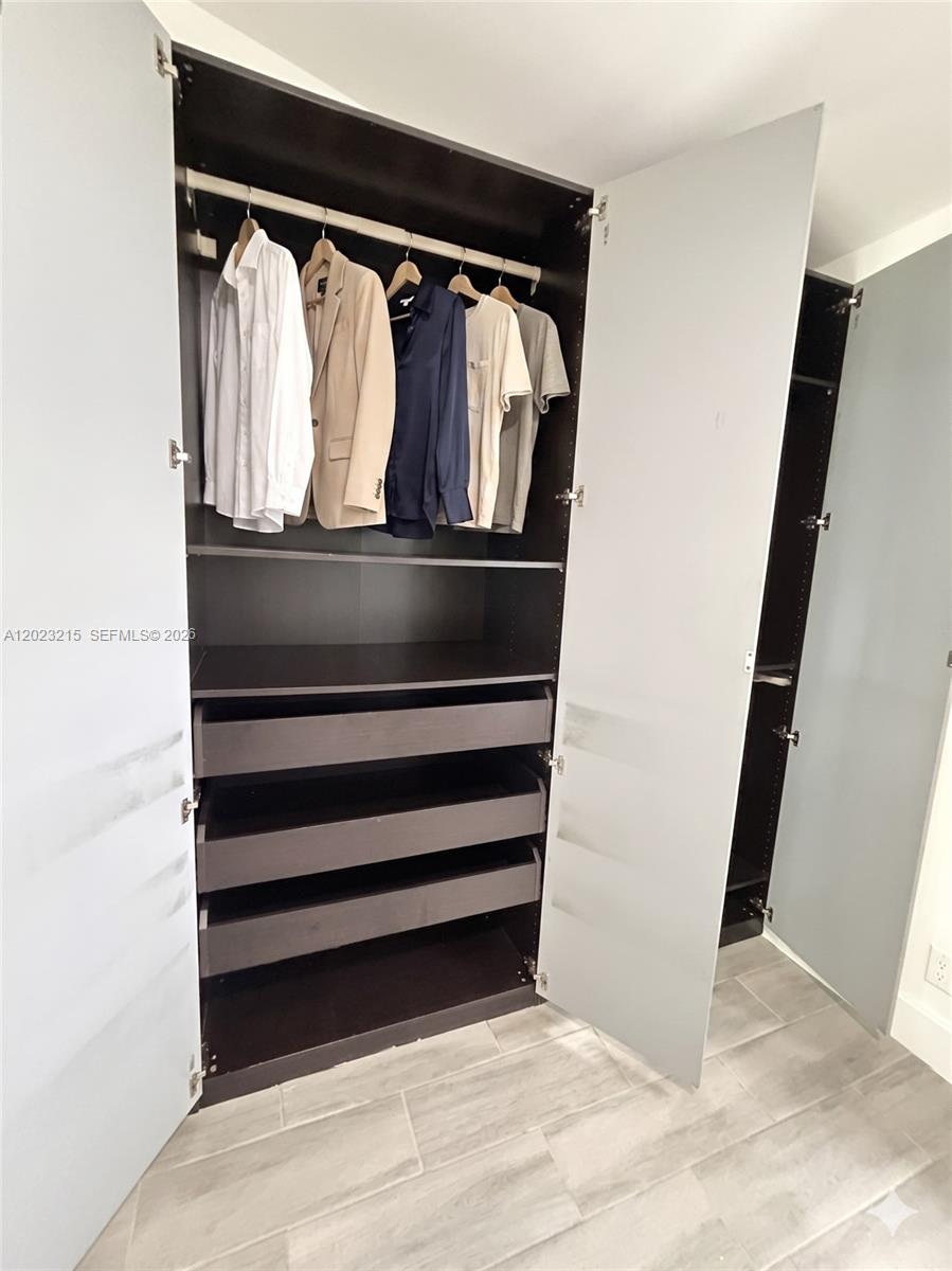 13 Southwest 3rd Street, Unit 13 Pompano Beach, FL 33060 - Photo 30 of 44 a view of walk in closet with clothes and shoes