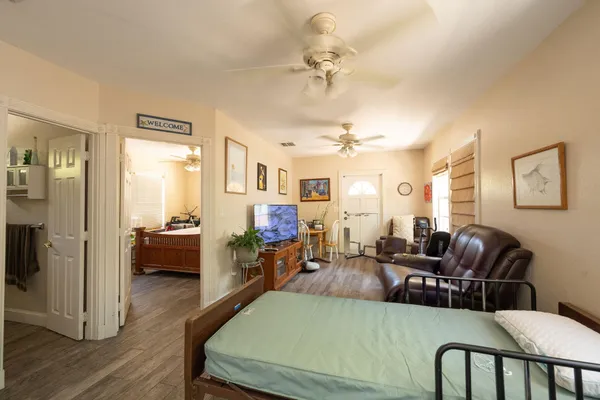 a bedroom with a bed and a flat screen tv
