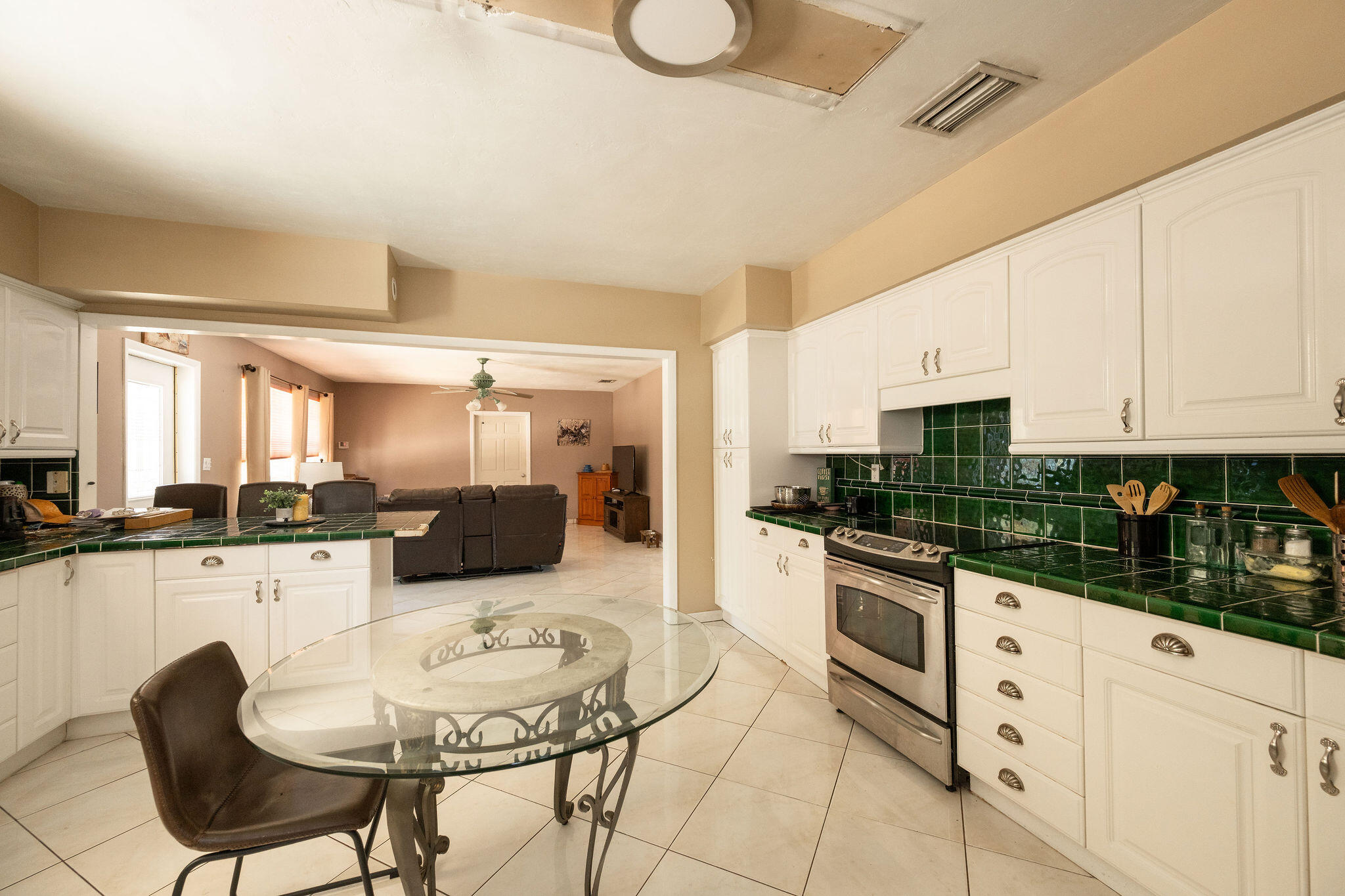 1409 4th Street Key West, FL 33040 - Photo 37 of 58 a kitchen with stainless steel appliances kitchen island granite countertop a sink and cabinets