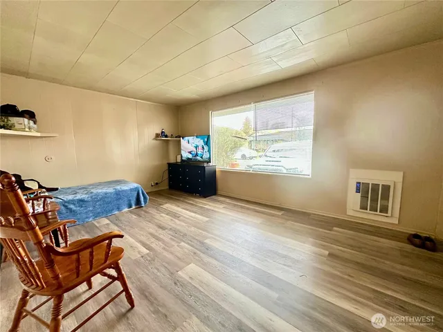a view of a livingroom with lounge chair and a ceiling fan