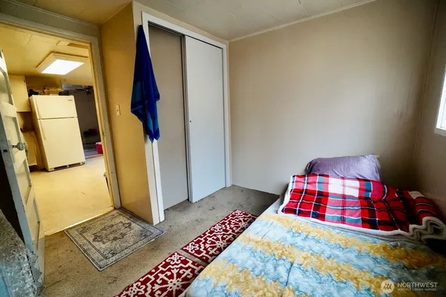 a bathroom with a granite countertop toilet sink and mirror