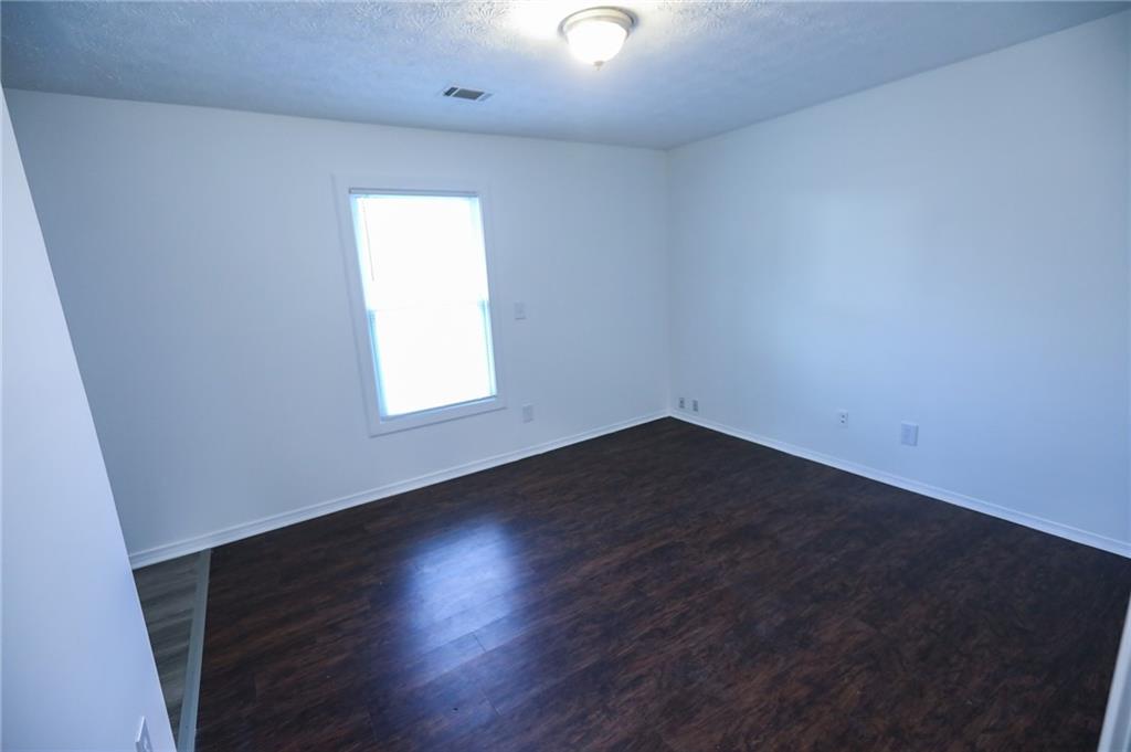 1967 Singer Way Lithonia, GA 30058 - Photo 14 of 28 an empty room with wooden floor and windows