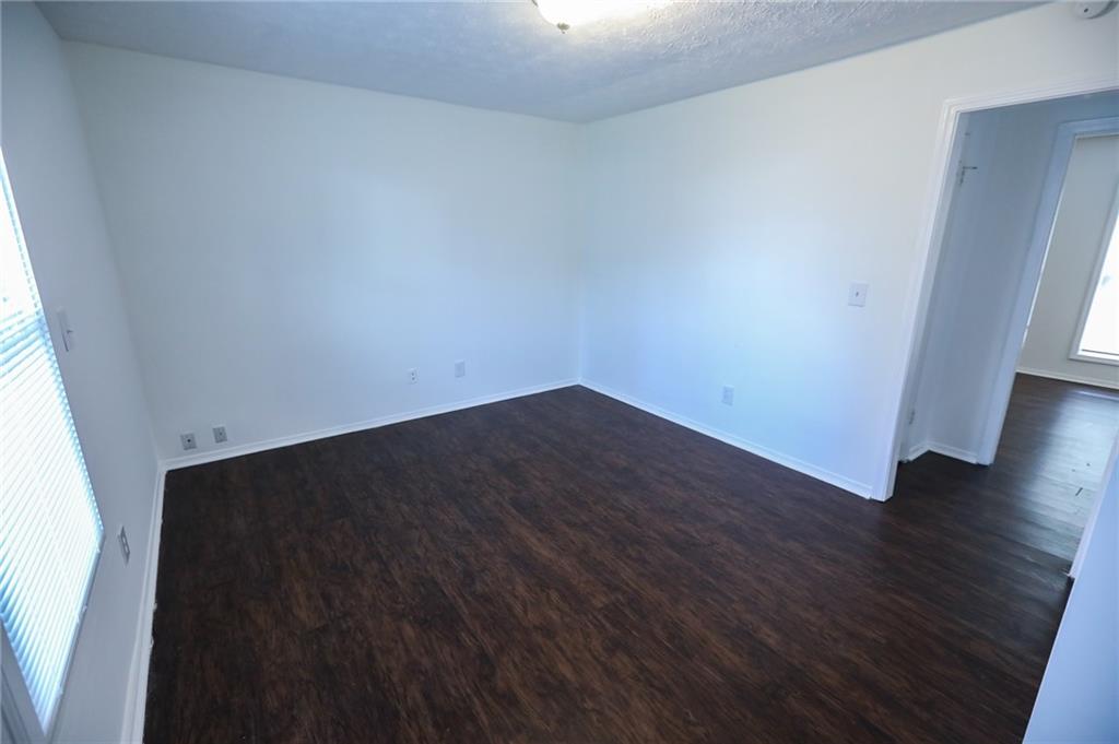 1967 Singer Way Lithonia, GA 30058 - Photo 15 of 28 an empty room with wooden floor