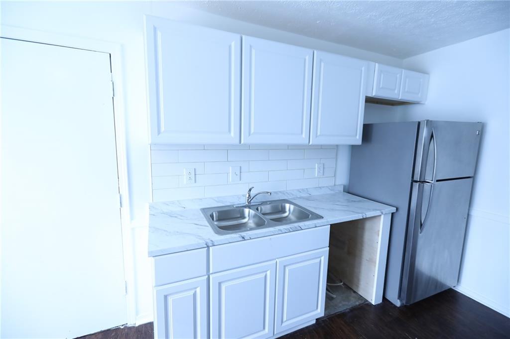 1967 Singer Way Lithonia, GA 30058 - Photo 24 of 28 a kitchen with stainless steel appliances granite countertop a sink stove and refrigerator