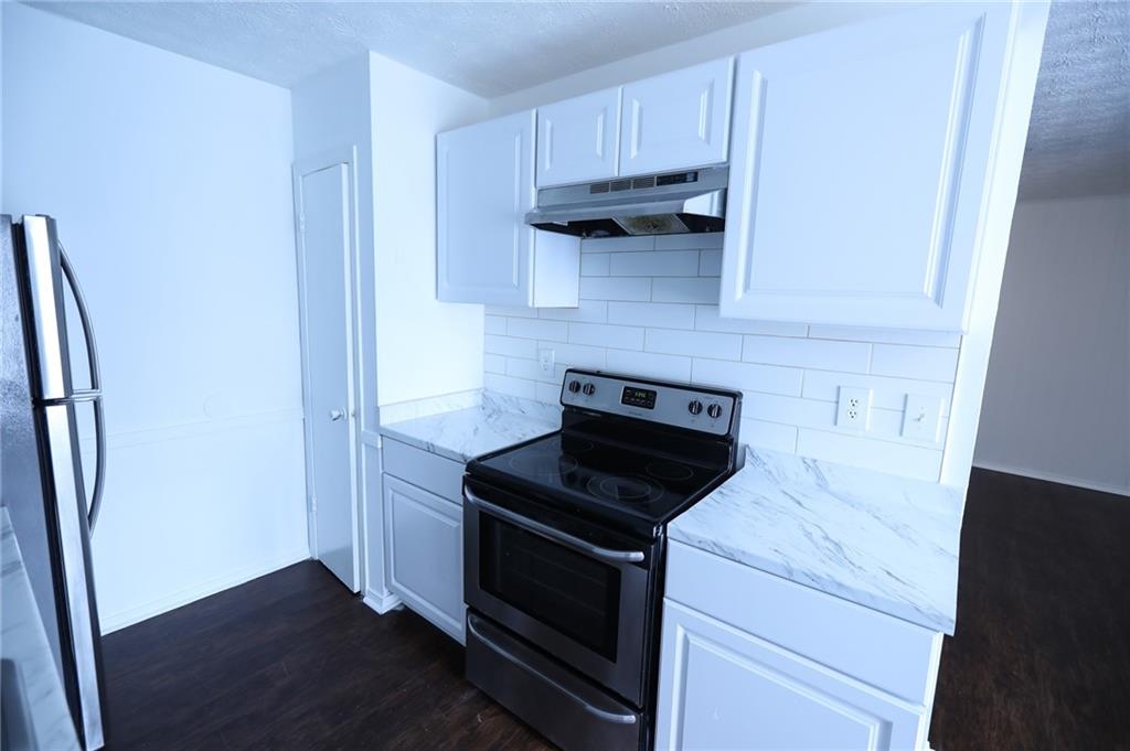 1967 Singer Way Lithonia, GA 30058 - Photo 25 of 28 a kitchen with stainless steel appliances a stove microwave and refrigerator