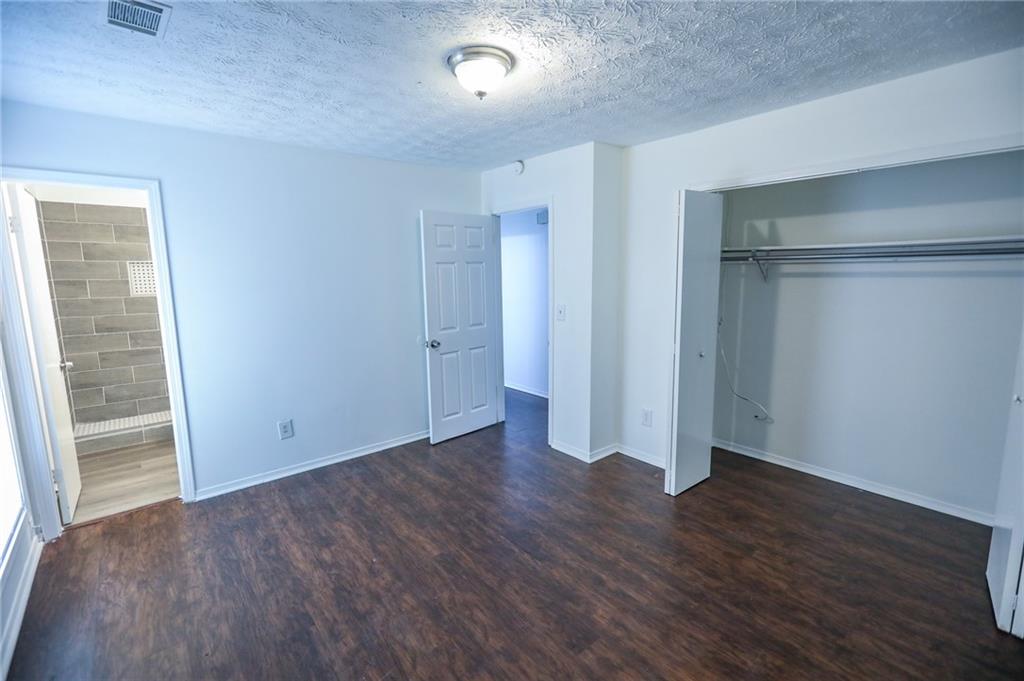 1967 Singer Way Lithonia, GA 30058 - Photo 5 of 28 an empty room with wooden floor & closet area