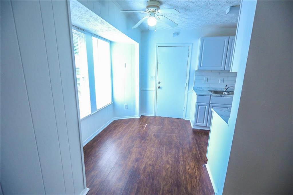 1967 Singer Way Lithonia, GA 30058 - Photo 6 of 28 a view of a hallway with wooden floors and a window