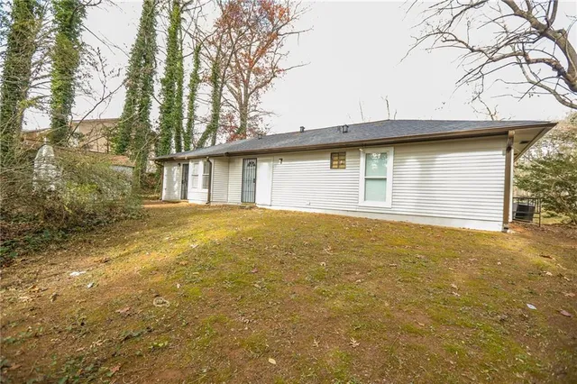 a view of a house with a yard and garage