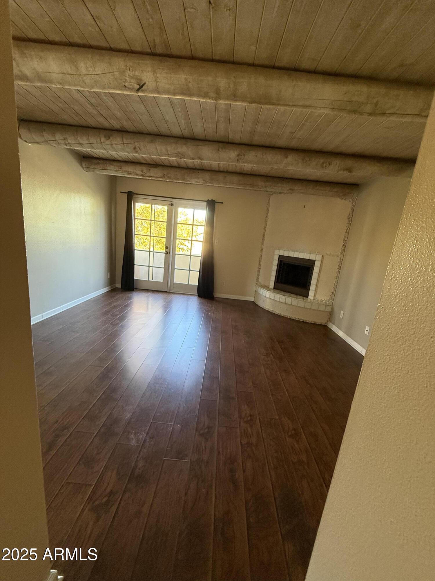 1425 East Desert Cove Avenue East, Unit 66 Phoenix, AZ 85020 - Photo 11 of 17 a view of a hallway with wooden floor and a fireplace