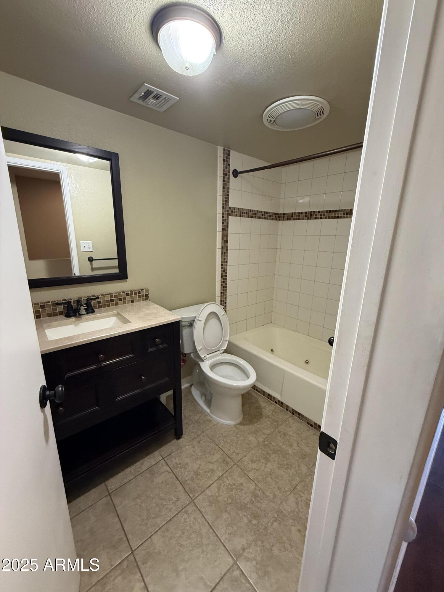 1425 East Desert Cove Avenue East, Unit 66 Phoenix, AZ 85020 - Photo 13 of 17 a bathroom with a sink a toilet and a shower