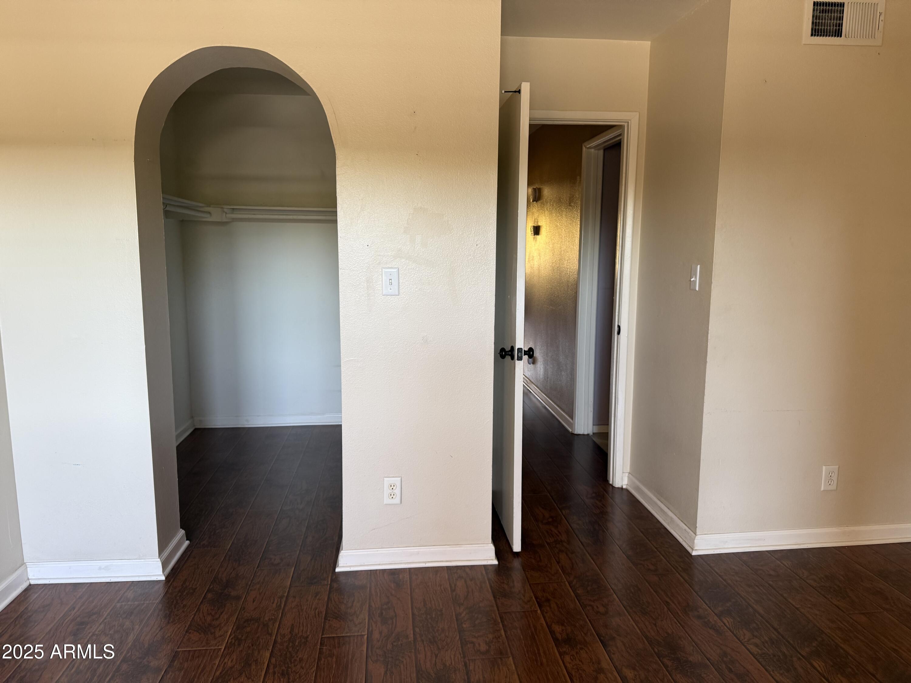 1425 East Desert Cove Avenue East, Unit 66 Phoenix, AZ 85020 - Photo 16 of 17 a view of a hallway with wooden floor