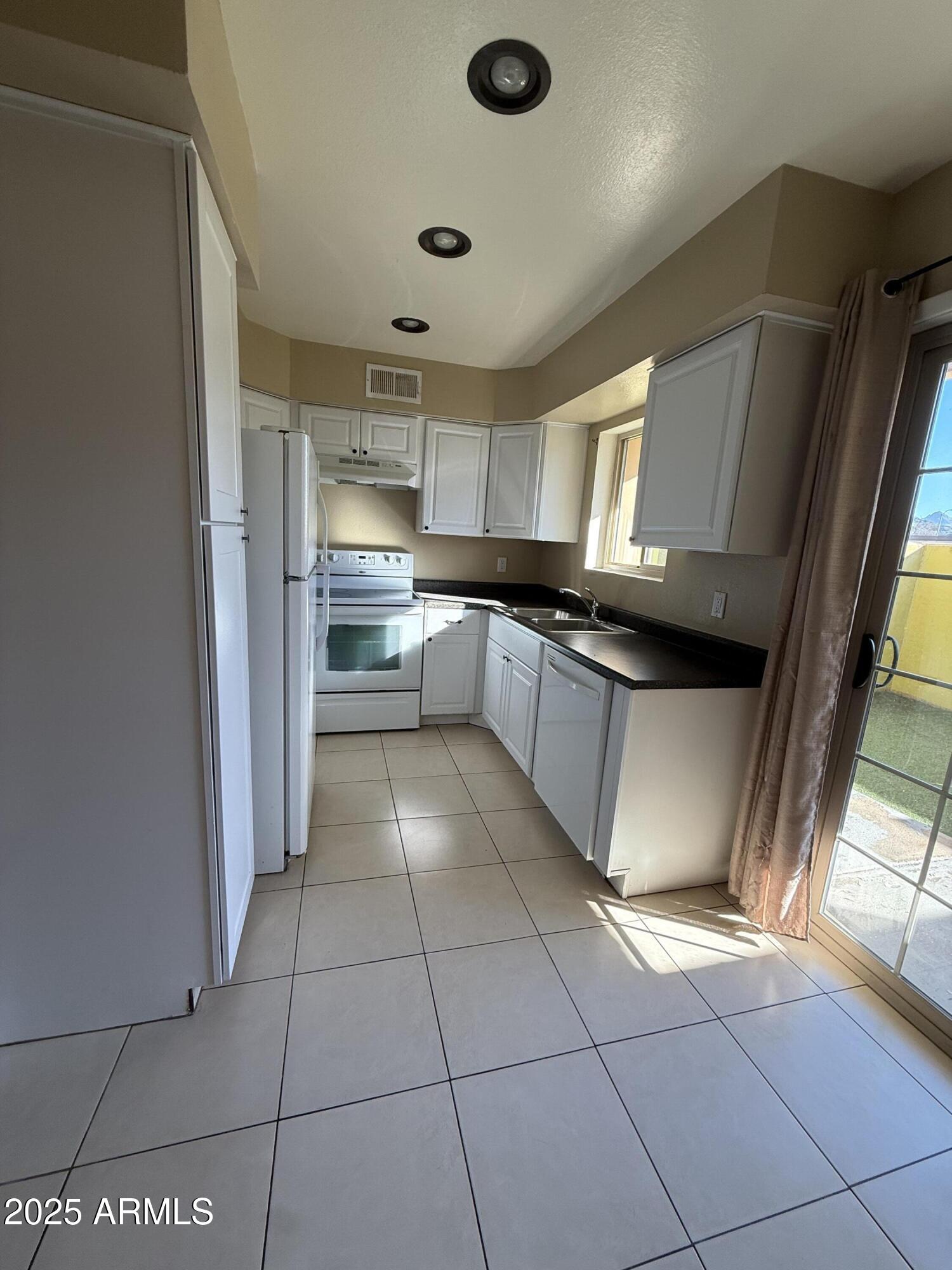 1425 East Desert Cove Avenue East, Unit 66 Phoenix, AZ 85020 - Photo 2 of 17 a kitchen with stainless steel appliances granite countertop a sink and cabinets