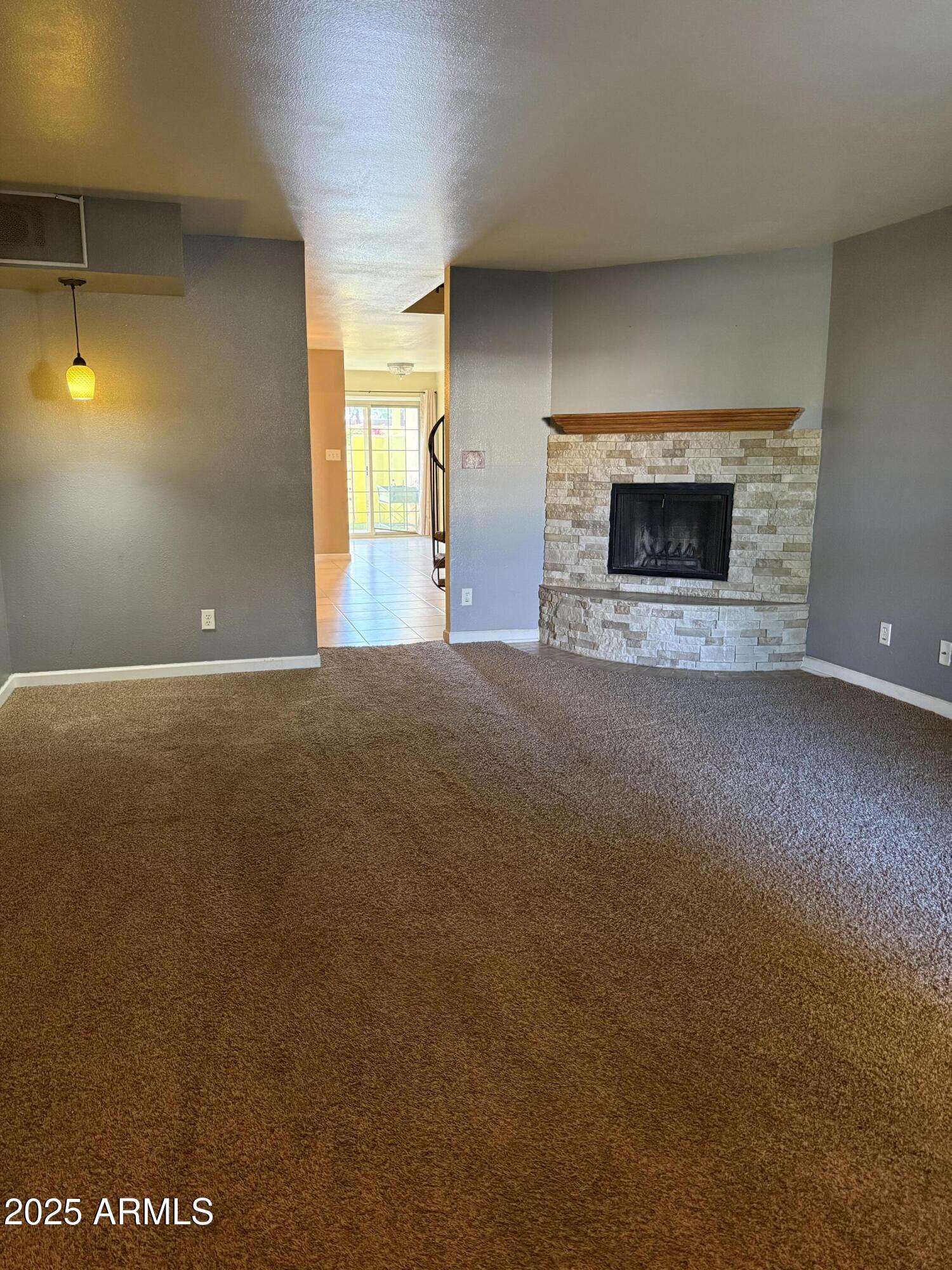 1425 East Desert Cove Avenue East, Unit 66 Phoenix, AZ 85020 - Photo 6 of 17 a view of empty room with a fireplace