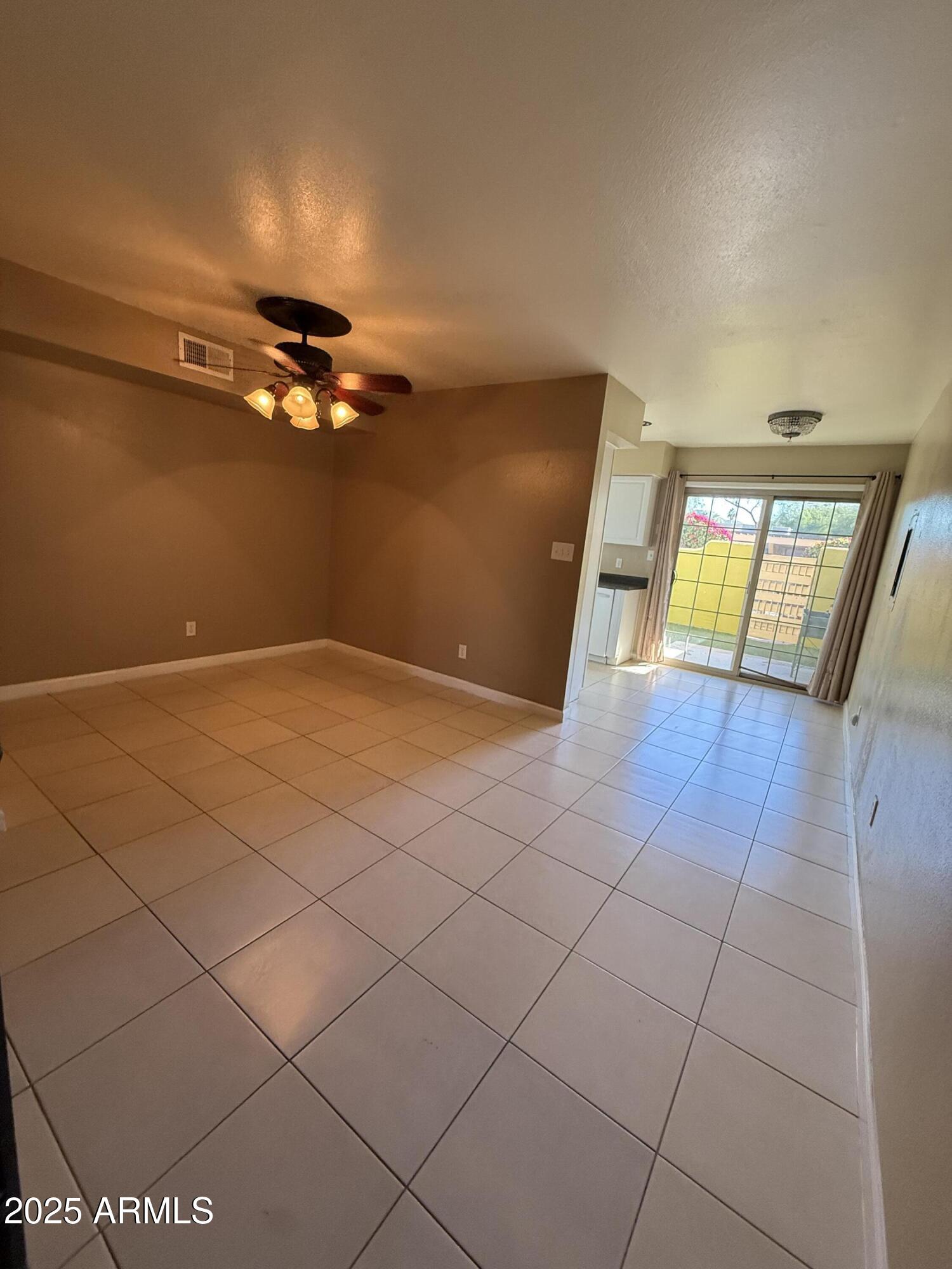 1425 East Desert Cove Avenue East, Unit 66 Phoenix, AZ 85020 - Photo 7 of 17 a view of an empty room and window