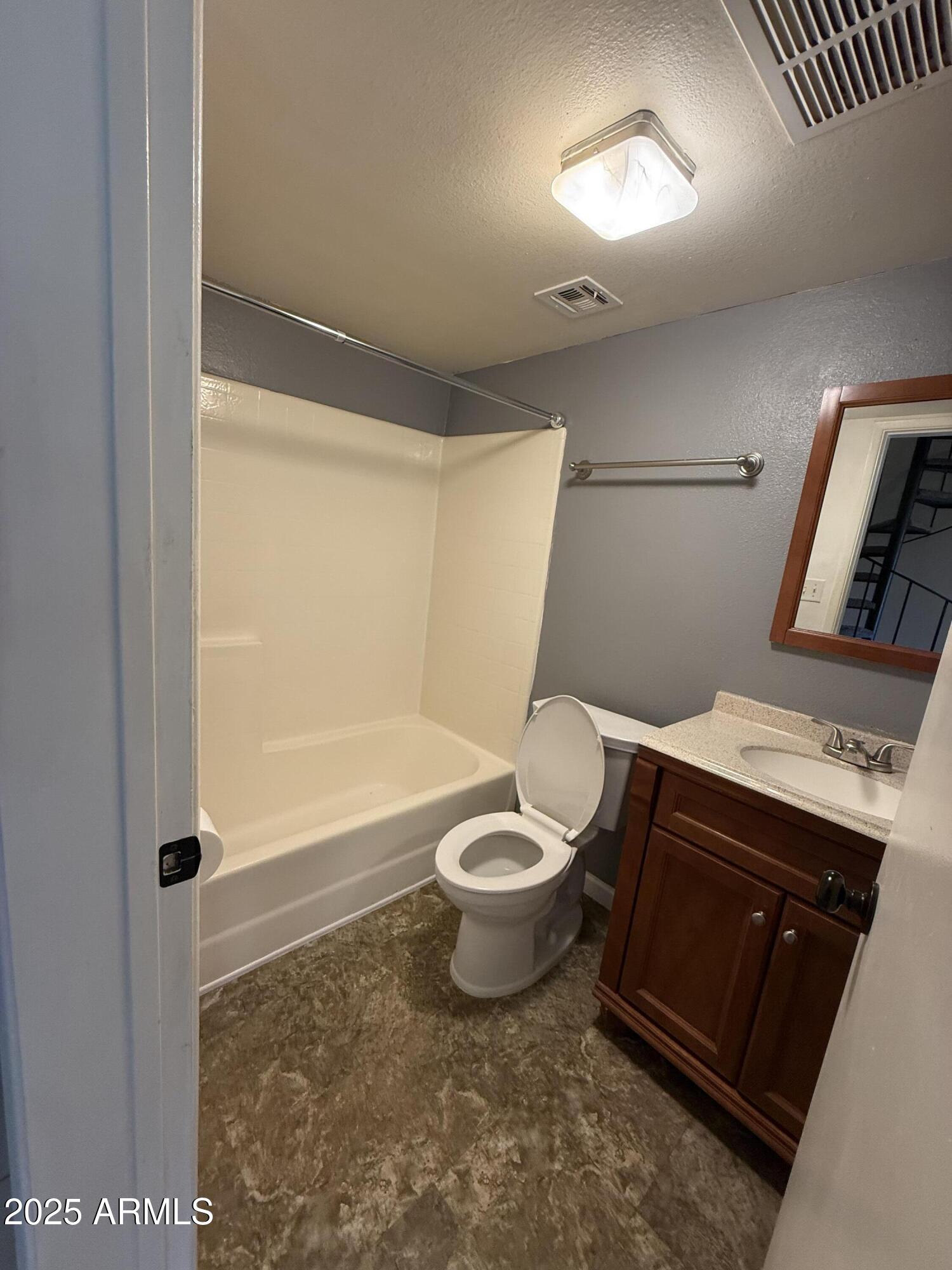 1425 East Desert Cove Avenue East, Unit 66 Phoenix, AZ 85020 - Photo 8 of 17 a bathroom with a toilet a sink and bathtub