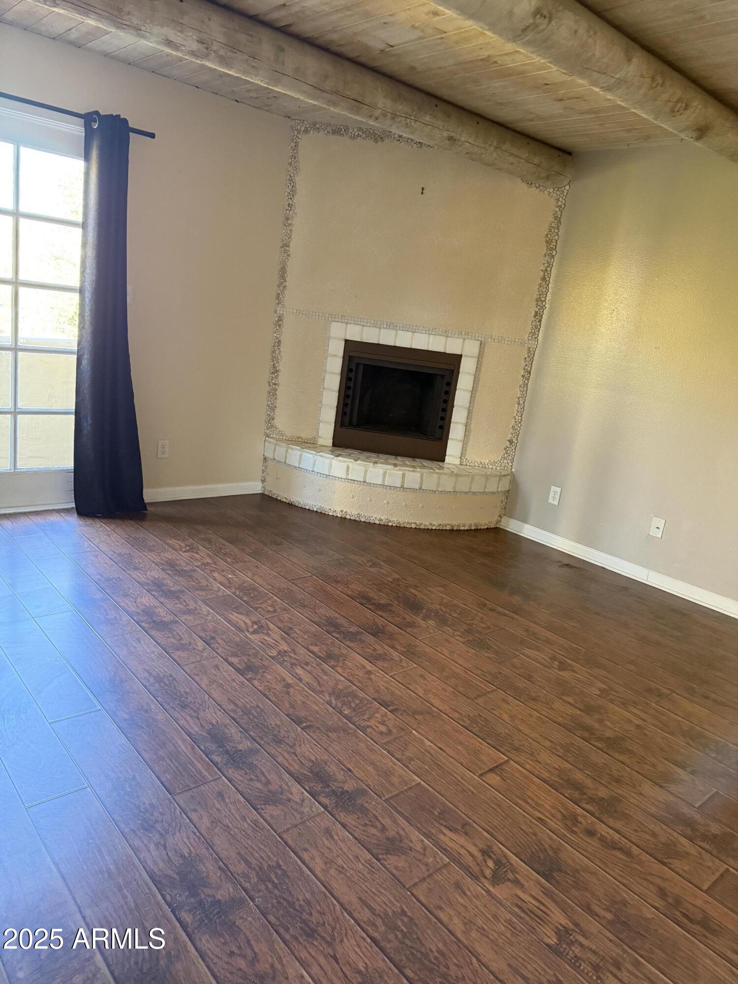1425 East Desert Cove Avenue East, Unit 66 Phoenix, AZ 85020 - Photo 10 of 17 a view of a livingroom with wooden floor and a fireplace