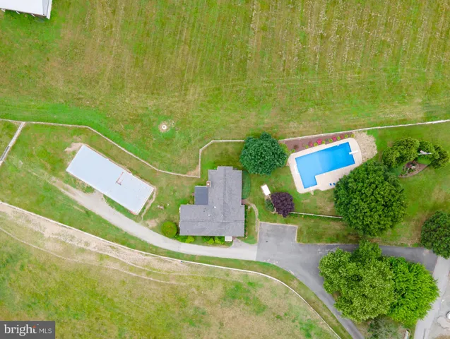 a view of a swimming pool with an outdoor space and seating area
