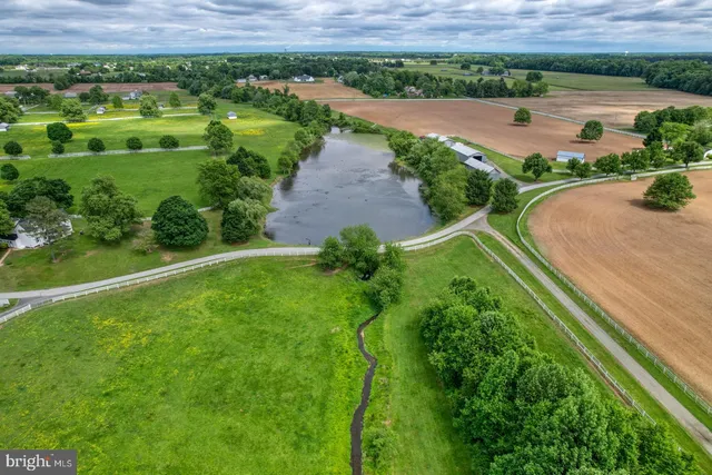 an aerial view of a garden with a lake view