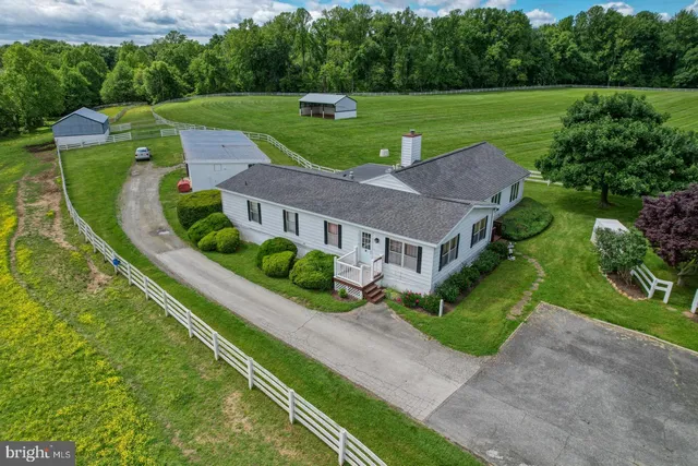 an aerial view of a house with a big yard