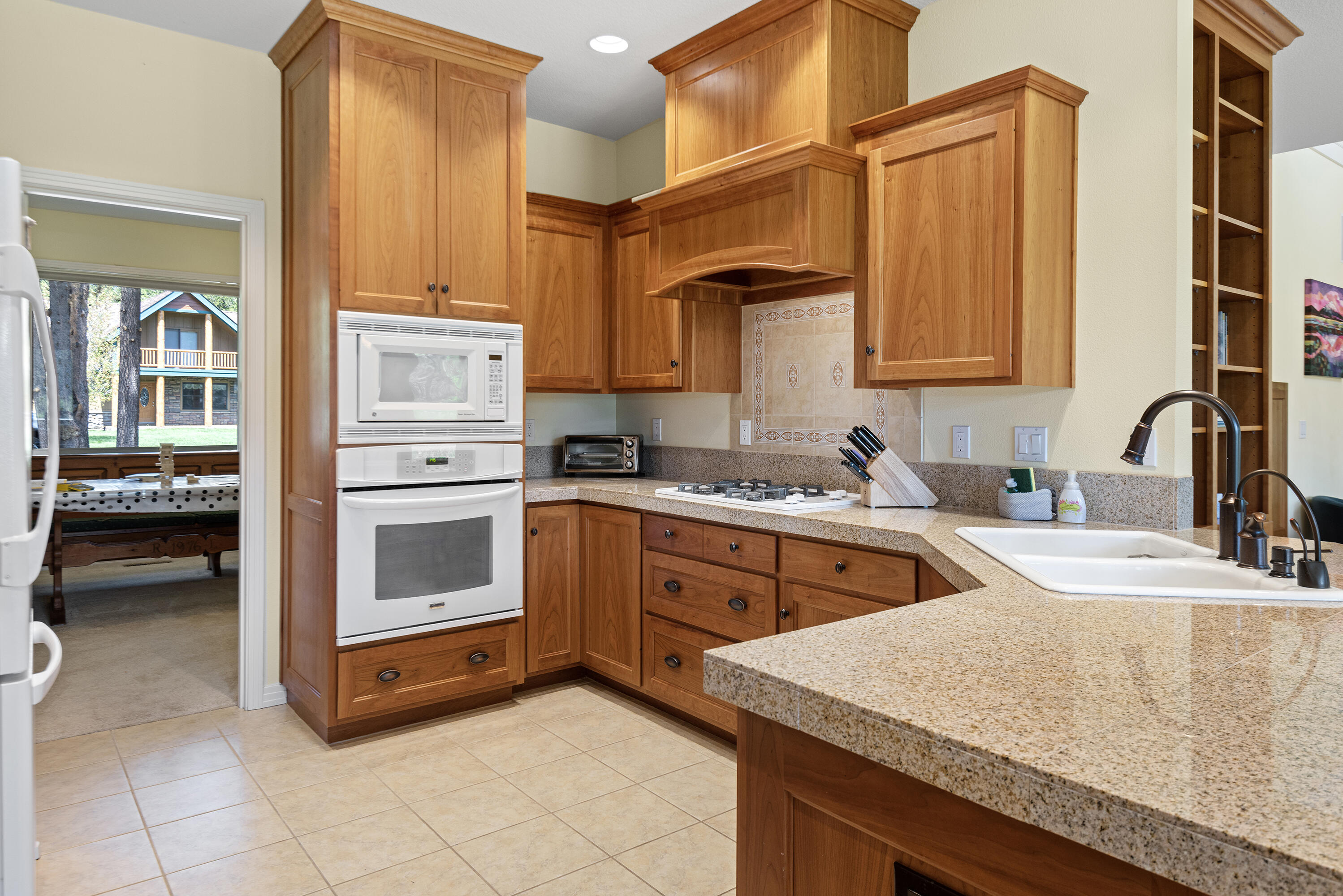 16775 Pony Express Way Bend, OR 97707 - Photo 8 of 38 a kitchen with stainless steel appliances granite countertop a sink and cabinets