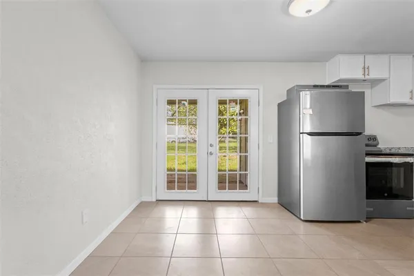 a kitchen with a refrigerator a stove a cabinets and a sink