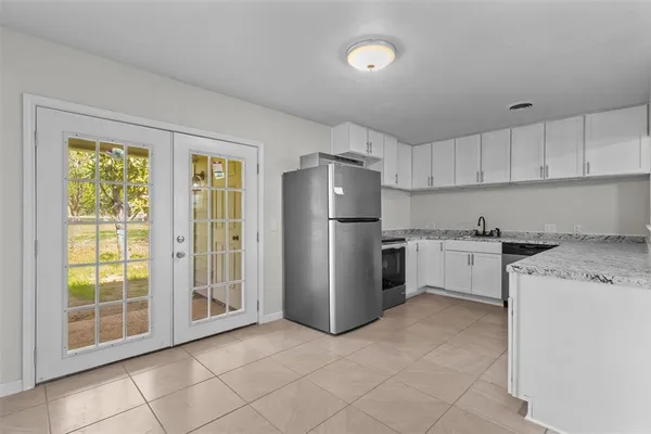 a kitchen with granite countertop cabinets stainless steel appliances and a counter space