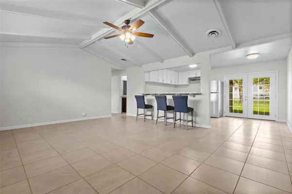 a view of a livingroom with furniture and chandelier fan