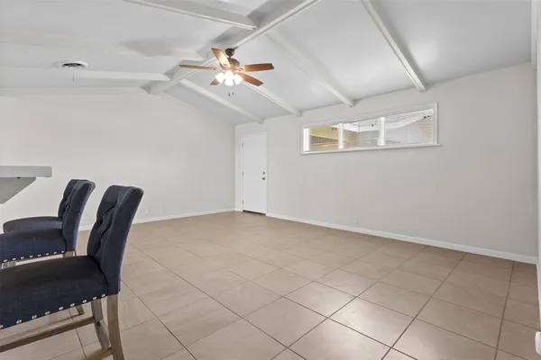 a view of a livingroom with furniture and chandelier fan