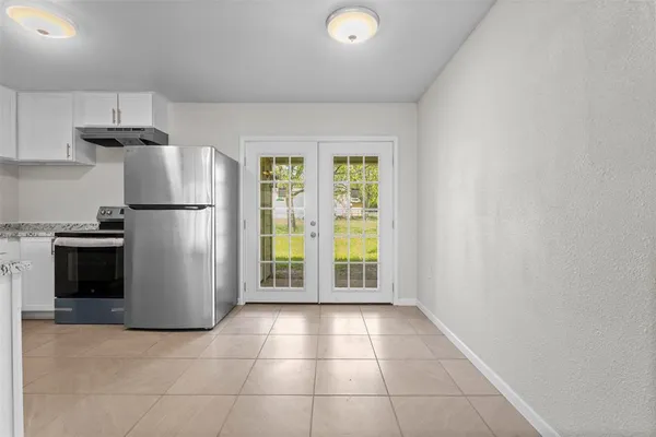 a view of a kitchen with a stove fridge and a window