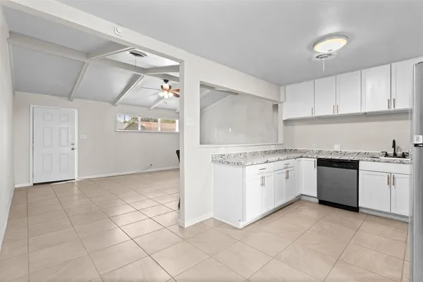 a kitchen with granite countertop cabinets and white appliances
