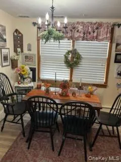 a dining room with furniture and window