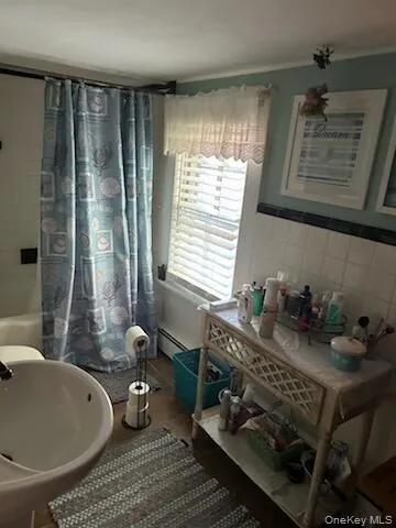 a bathroom with a tub sink and mirror