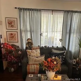 a living room with furniture and flowers