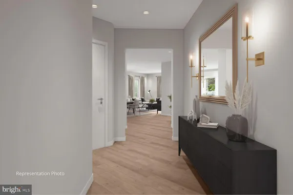 a living room with furniture and a large mirror next to a window