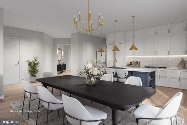 a kitchen with granite countertop a table chairs stove and view living room