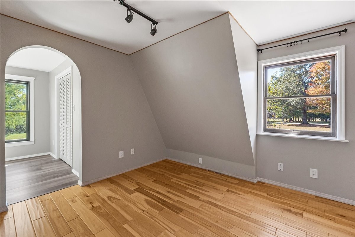 613 New Hope Road Manchester, TN 37355 - Photo 13 of 50 en empty room with wooden floor and windows