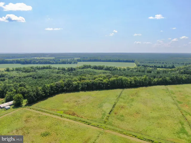 a view of a big yard with an outdoor seating