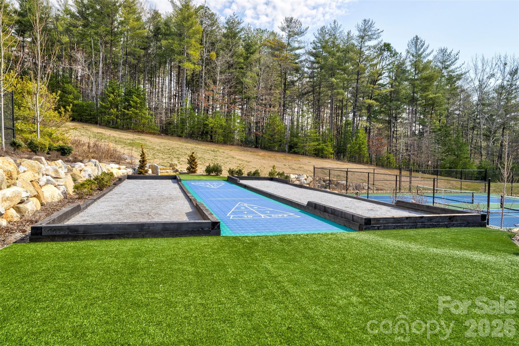2086 October Drive, Unit 147 Nebo, NC 28761 - Photo 23 of 29 a view of a park with large trees and a wooden fence