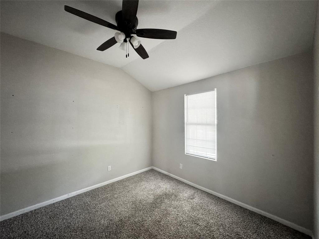 314 North Dubellette Street Weatherford, TX 76086 - Photo 18 of 30 an empty room with a window and a ceiling fan