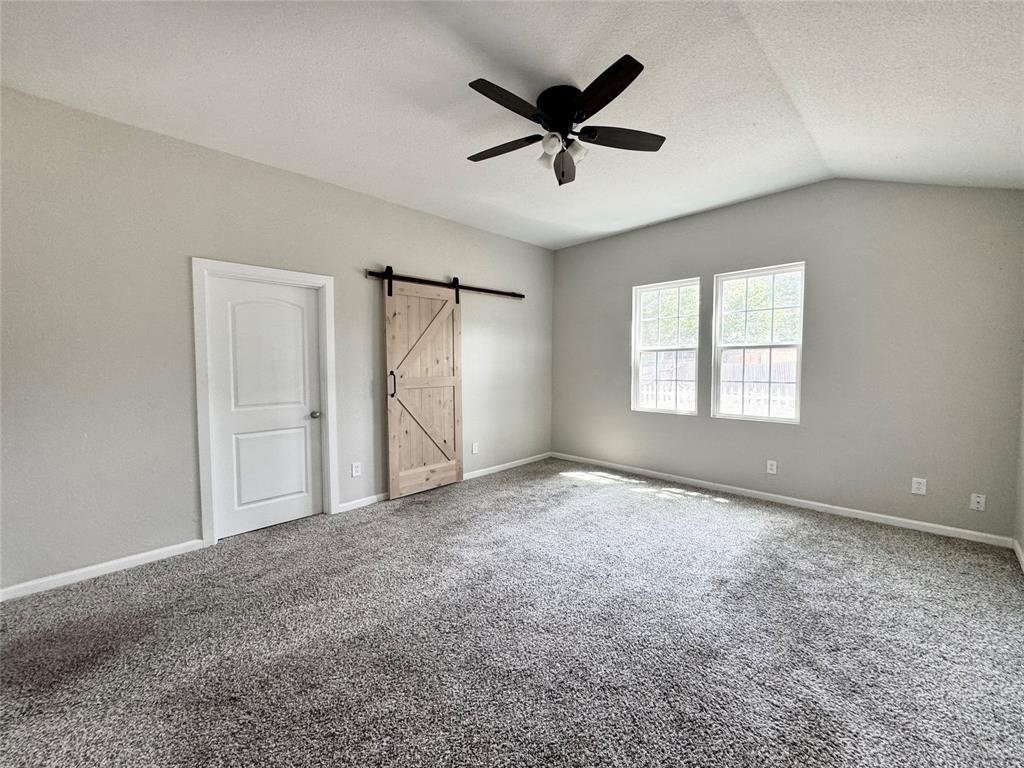 314 North Dubellette Street Weatherford, TX 76086 - Photo 19 of 30 an empty room with ceiling fan and windows
