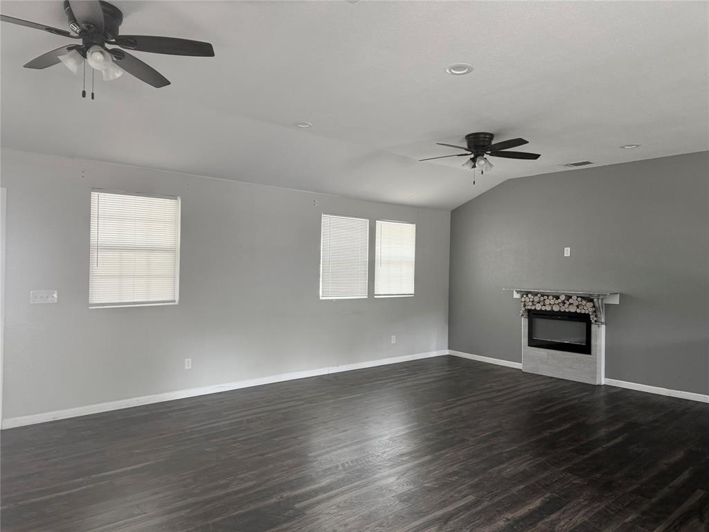 314 North Dubellette Street Weatherford, TX 76086 - Photo 3 of 30 wooden floor in an empty room with a window