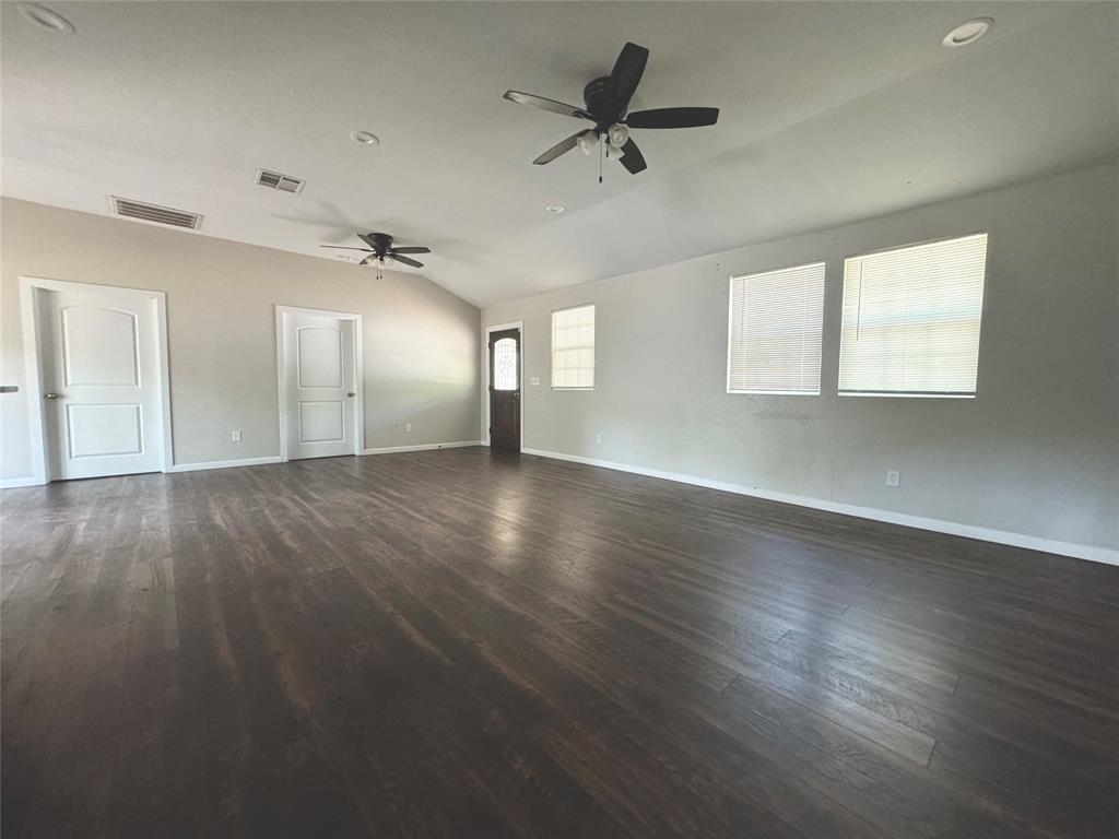 314 North Dubellette Street Weatherford, TX 76086 - Photo 4 of 30 a view of empty room with wooden floor and fan