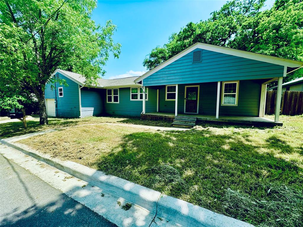 314 North Dubellette Street Weatherford, TX 76086 - Photo 5 of 30 a front view of a house with a yard and trees