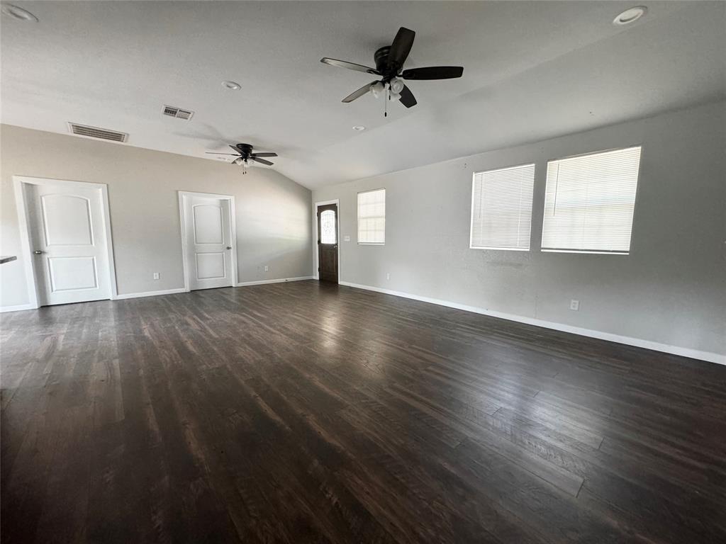 314 North Dubellette Street Weatherford, TX 76086 - Photo 6 of 30 a view of an empty room with wooden floor and a window
